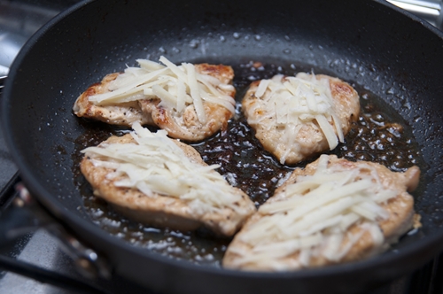 chicken fillets frying in a pan
